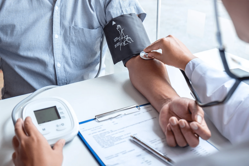 Photo of a blood pressure reading with a blood pressure cuff on the patient's arm